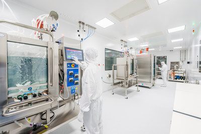 Laboratory technicians operating in an upstream GMP manufacturing cleanroom of the new state-of-the-art plants of Exothera.